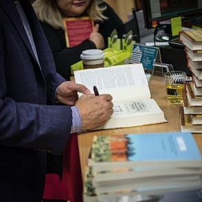 An author signs a book duirng an event at This House of Books in downtown Billings (Photo courtesy of This House of Books).